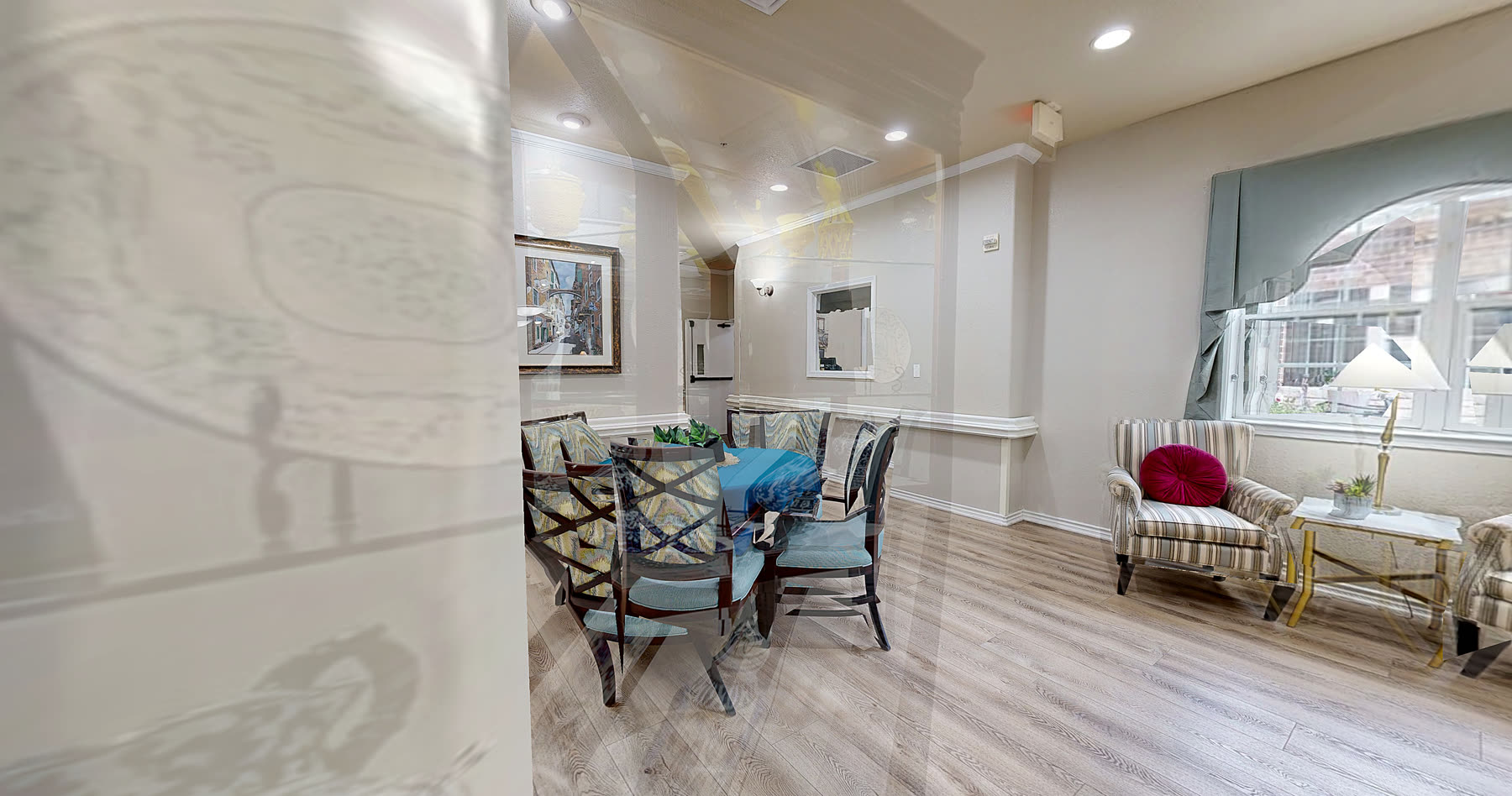 Dining nook with a set table beside a sunny sitting area