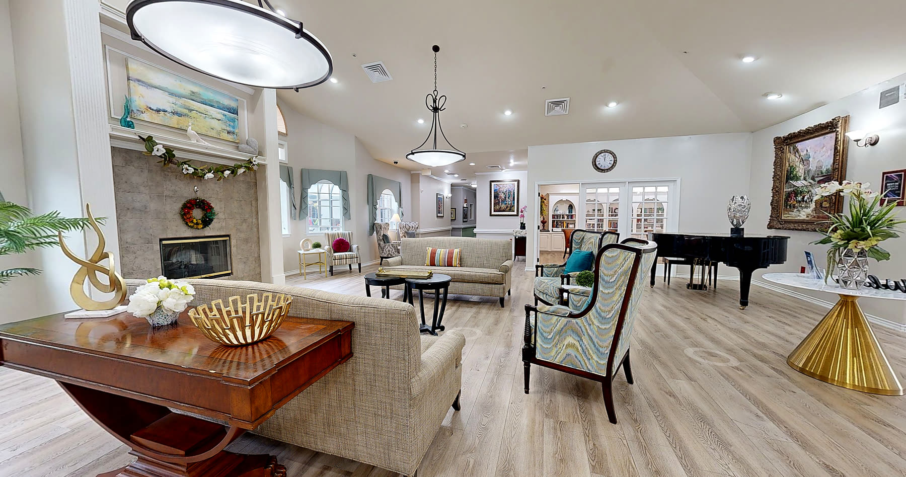 Fireplace lounge with armchairs and a grand piano