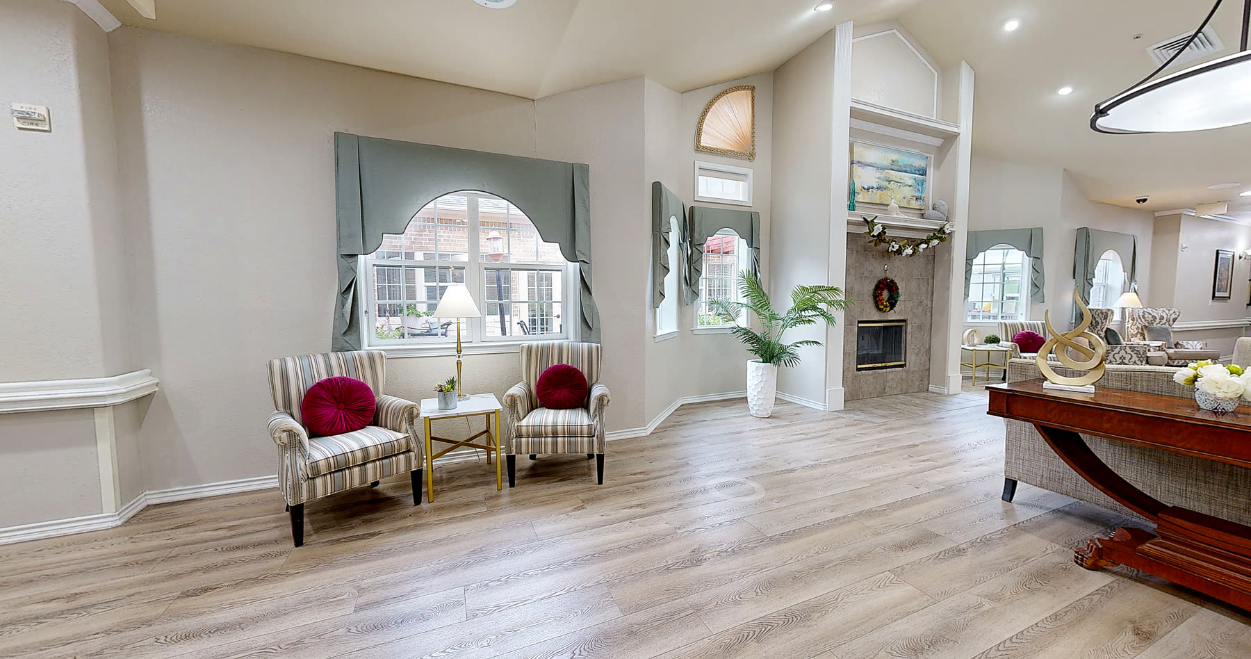 Sitting area by the fireplace with garden views