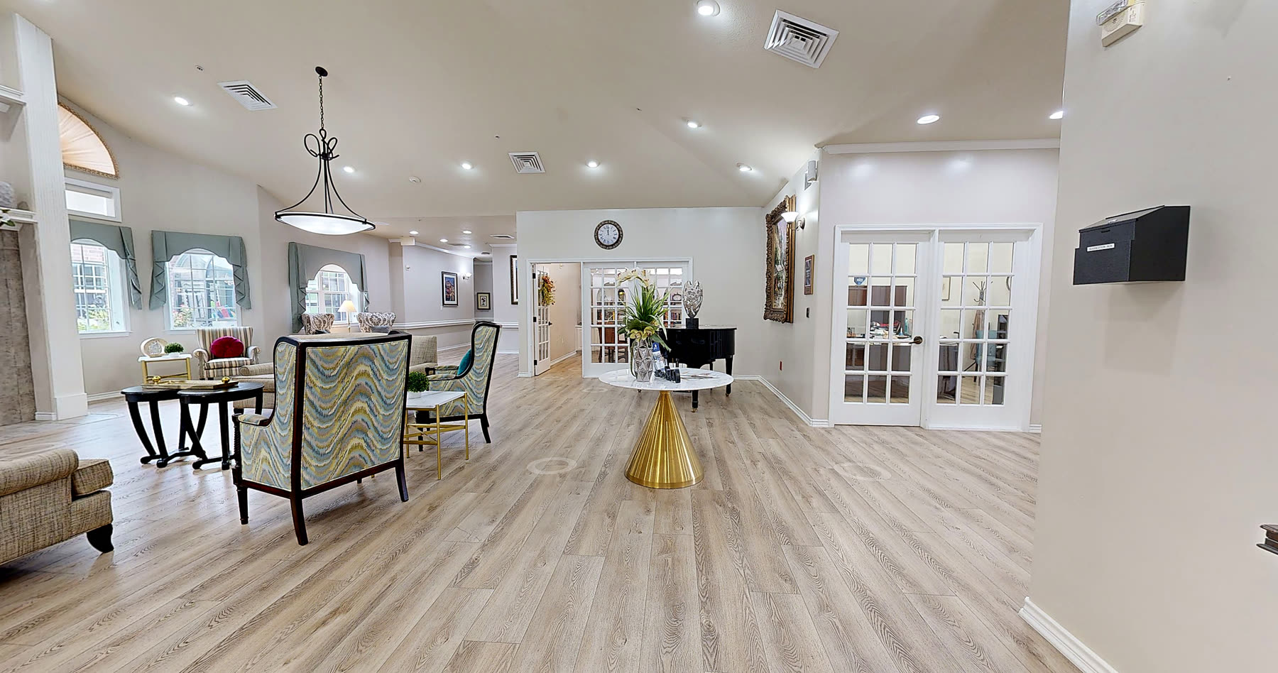 Great room seating area looking toward the grand piano and french doors